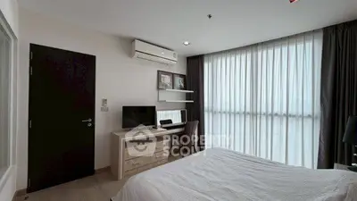 Modern bedroom with large window, desk, and air conditioning in a stylish apartment.