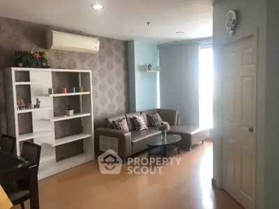 Charming living room with modern decor, cozy seating, and ample natural light, perfect for relaxation and entertaining.