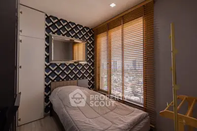 Cozy bedroom with modern decor and city view through large windows