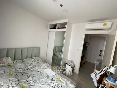 Cozy bedroom with mirrored closet and air conditioning in modern apartment