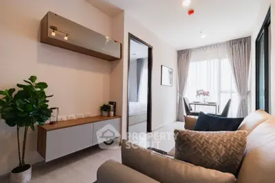 Modern living room with stylish decor and natural light, featuring a cozy seating area and elegant furnishings.