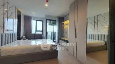 Modern bedroom with large windows and stylish decor in a high-rise apartment.