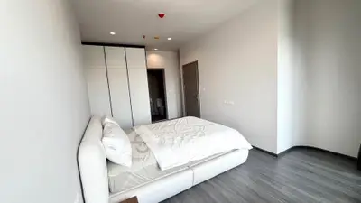Spacious modern bedroom with sleek design and ample natural light
