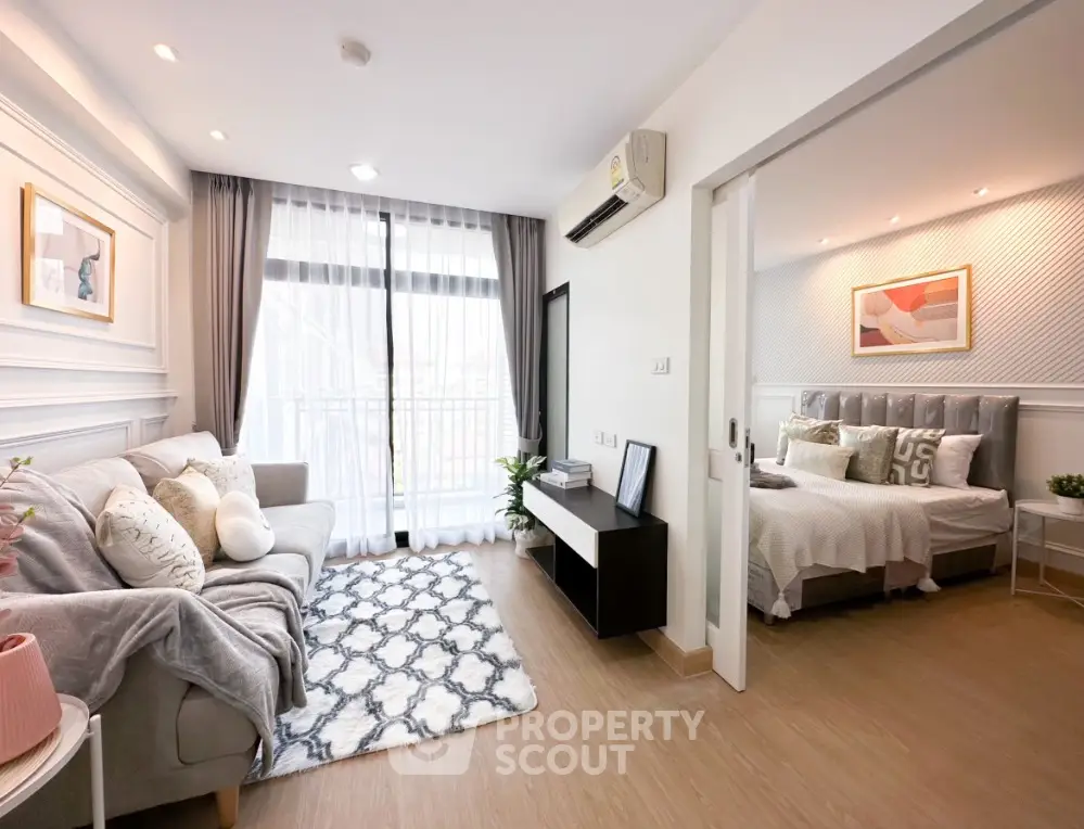 Modern living room with cozy decor and adjacent bedroom in stylish apartment