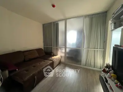 Cozy living room with brown sectional sofa and frosted glass sliding doors