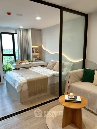 Modern bedroom with cozy decor and natural light, featuring a stylish glass partition and elegant furnishings.