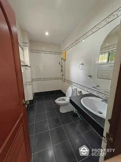 Spacious bathroom with modern fixtures and elegant tile design