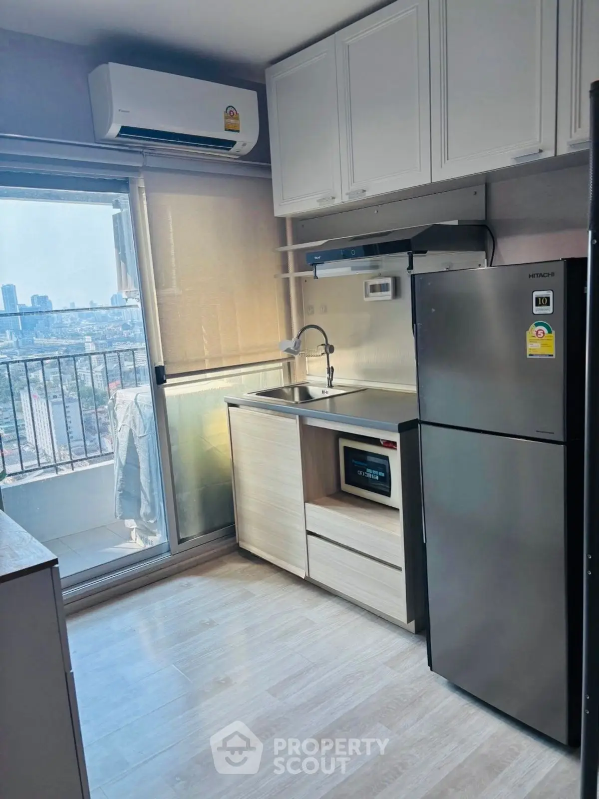 Modern kitchen with balcony view in high-rise apartment