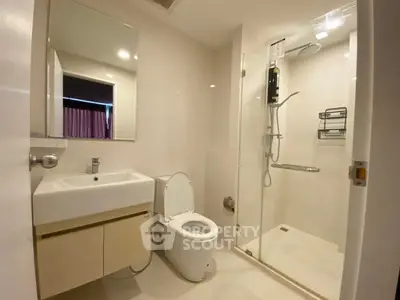 Modern bathroom with sleek fixtures and glass shower enclosure
