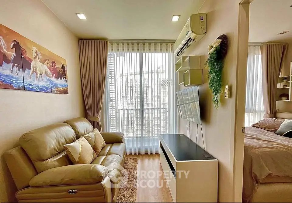 Cozy living room with modern decor and natural light in a stylish apartment.