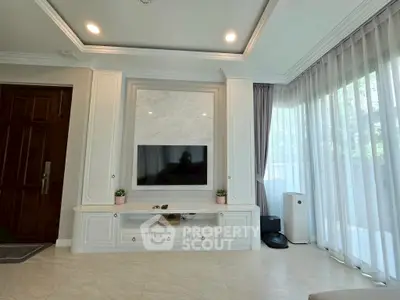 Elegant living room with large windows and modern entertainment center