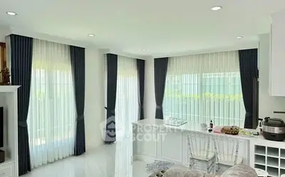 Elegant modern living room with large windows and stylish curtains