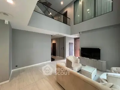 Spacious modern living room with high ceilings and elegant furnishings in a luxury apartment.