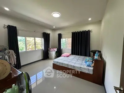 Spacious bedroom with large windows and modern decor