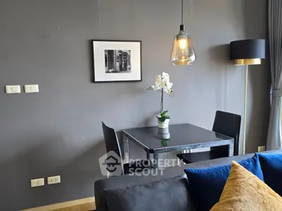 Modern living room with stylish dining area and elegant lighting