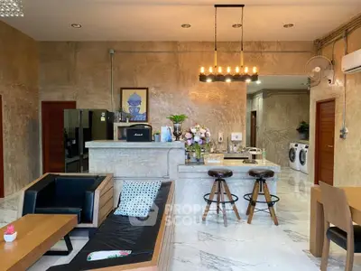 Luxurious open-plan living room with modern kitchen and stylish decor