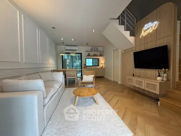 Stylish modern living room with cozy sofa, wooden flooring, and elegant decor in a contemporary home.