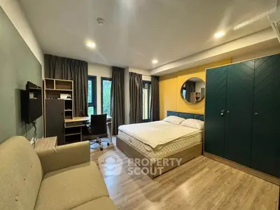 Modern studio apartment with stylish decor, featuring a cozy bed, study area, and elegant furnishings.