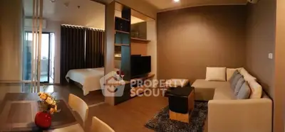 Modern open-plan living room with cozy seating and stylish decor in a contemporary apartment.