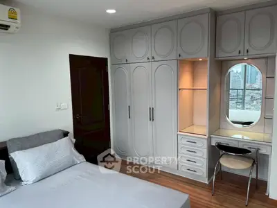 Spacious bedroom with built-in wardrobe and city view, perfect for modern living.