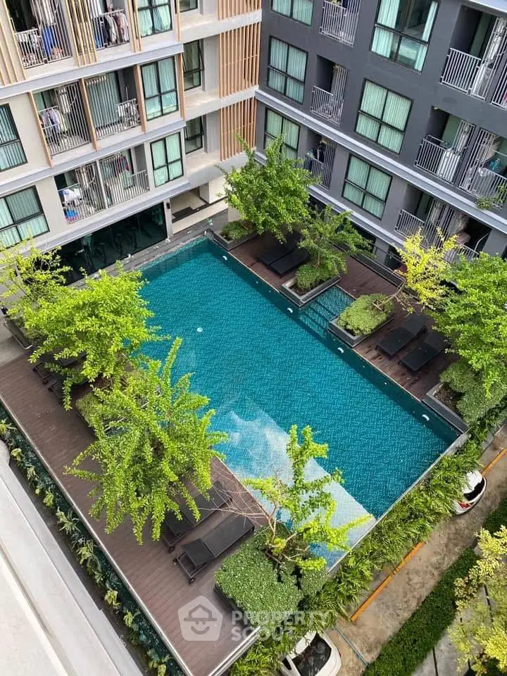Modern apartment complex with stunning pool and lush greenery