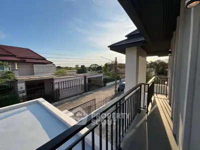 Charming balcony view in a modern residential neighborhood at sunset.