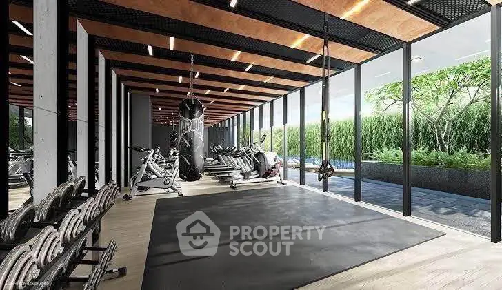 Modern gym with floor-to-ceiling windows and lush outdoor view, featuring state-of-the-art equipment.