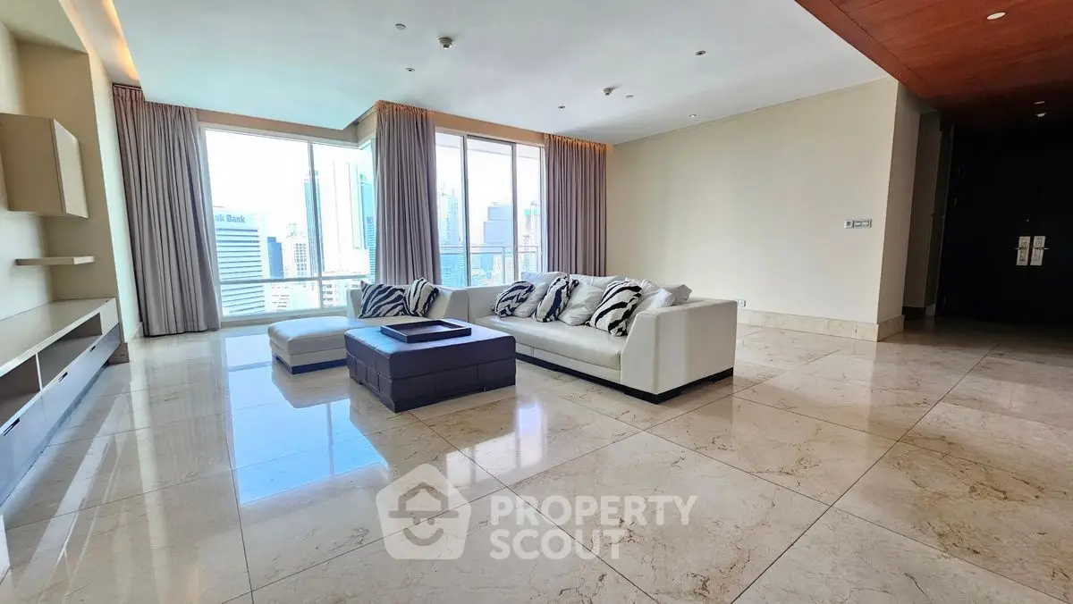 Spacious modern living room with city view and elegant marble flooring.