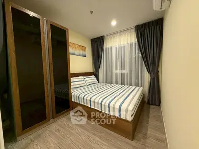 Cozy bedroom with modern decor and large wardrobe in a stylish apartment.
