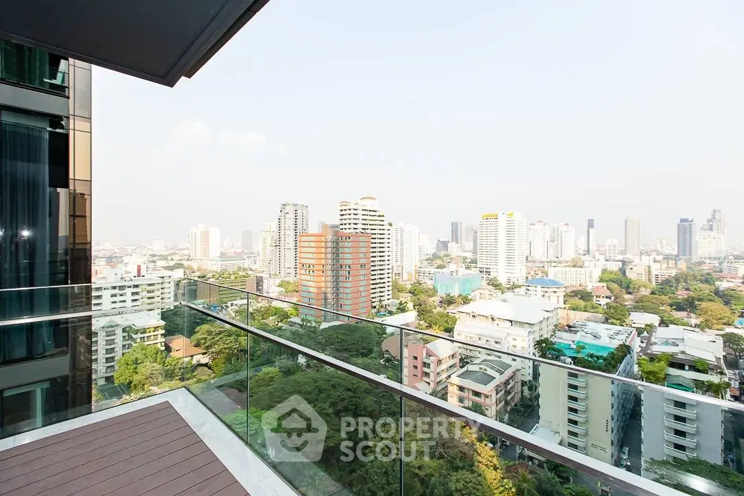 Stunning cityscape view from modern balcony with glass railing