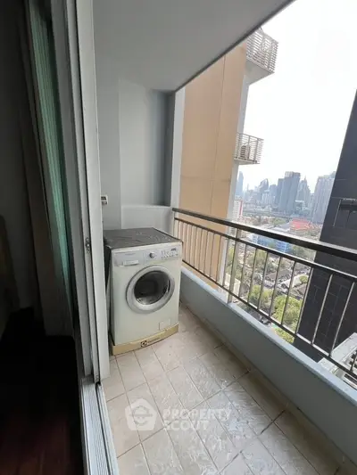 High-rise apartment balcony with washing machine and city view, ideal for urban living.