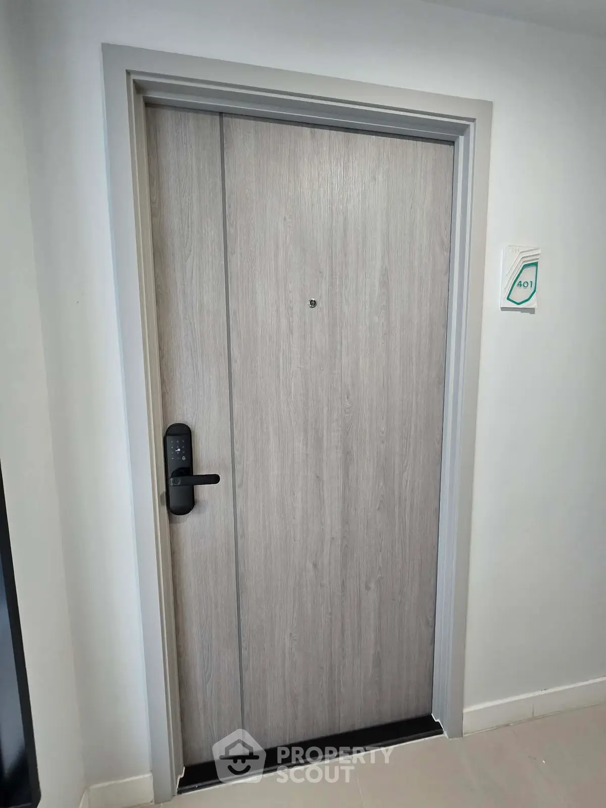 Modern apartment entrance with sleek wooden door and digital lock system.