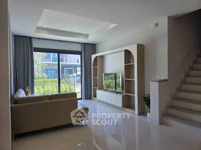 Modern living room with sleek design and large window view