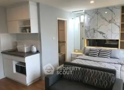 Modern studio apartment with compact kitchen and cozy bedroom