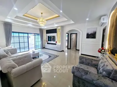 Luxurious living room with elegant chandelier and plush seating, featuring modern decor and spacious layout.