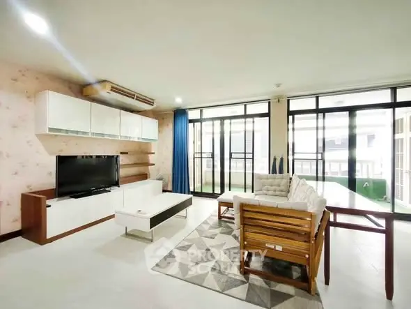 Spacious living room with modern furniture and large windows for natural light.