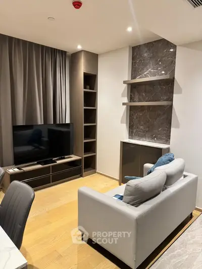 Modern living room with sleek furniture and marble accent wall