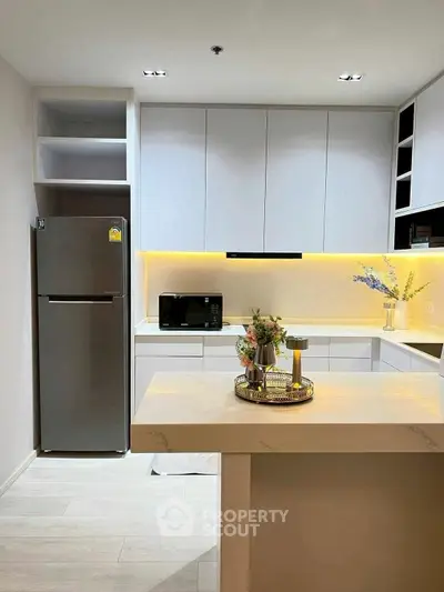 Modern kitchen with sleek design and ambient lighting