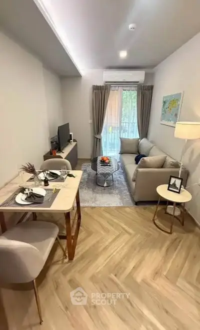 Modern living room with cozy seating and stylish decor, featuring a small dining area and natural light.