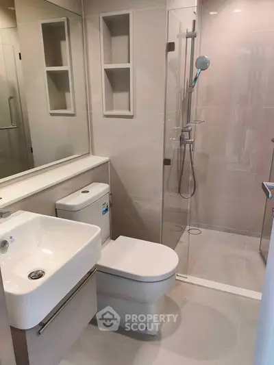 Modern bathroom with sleek fixtures and glass shower enclosure