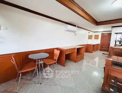 Spacious living area with modern furniture and elegant wood paneling