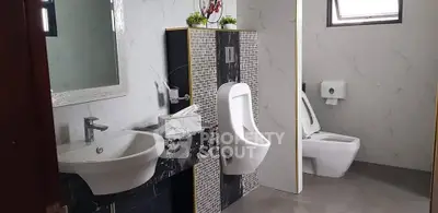 Modern bathroom with urinals and toilet in sleek marble design