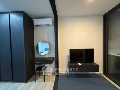 Modern living room with sleek TV setup and stylish vanity area