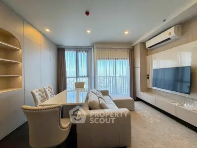 Luxurious modern living room with elegant furniture and large windows offering natural light.