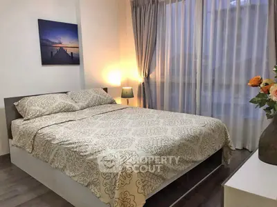 Cozy bedroom with elegant decor and large window for natural light