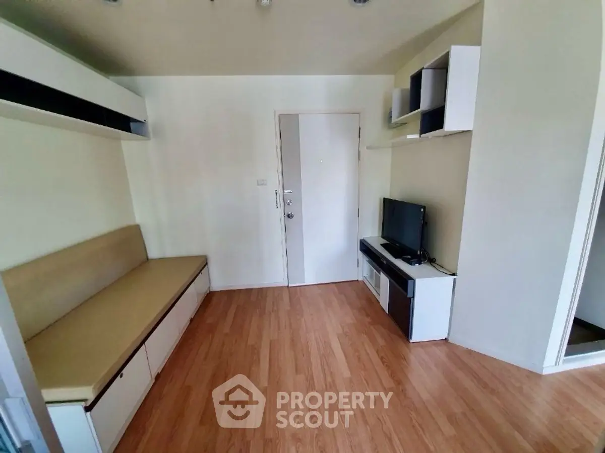 Modern living room with wooden flooring and built-in furniture