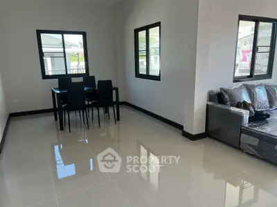 Modern living room with sleek dining area and large windows