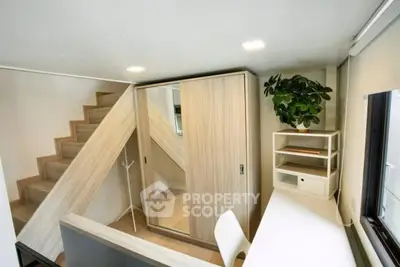 Modern compact study area with built-in storage under stairs and natural light.