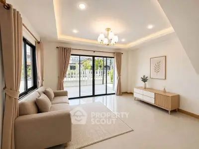 Spacious living room with elegant decor and large windows offering natural light.