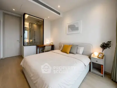 Modern bedroom with stylish decor and ensuite bathroom, featuring cozy bed and elegant furnishings.